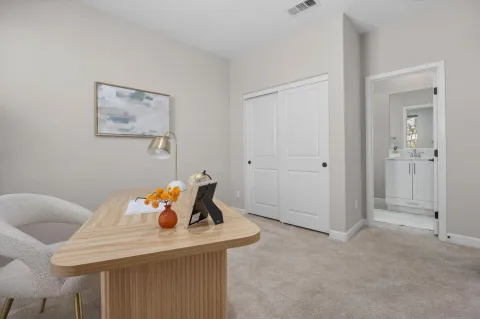 a view of a room that has a table and chairs in it