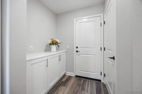 a kitchen that has a lot of cabinets a sink and appliances in it