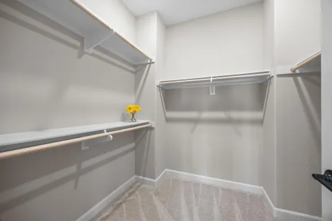 a view of a hallway with wooden floor and entryway