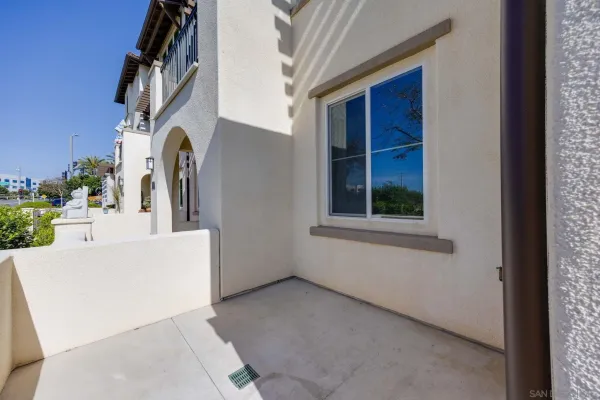 a front view of a house with plants and trees