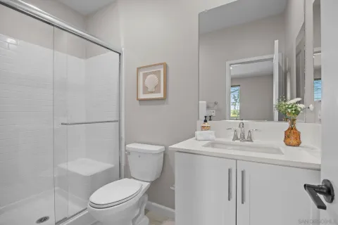 a bathroom with a sink a toilet and shower