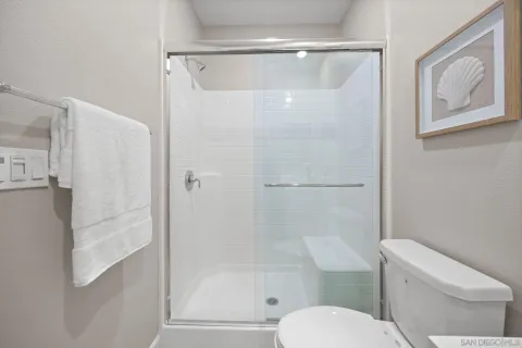 a white toilet sitting next to a bath tub shower