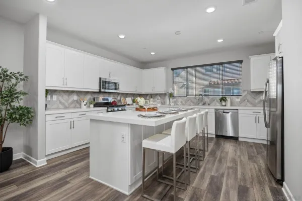 a kitchen with a sink window stainless steel appliances and cabinets