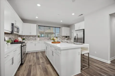 a kitchen with a sink a window stainless steel appliances and cabinets