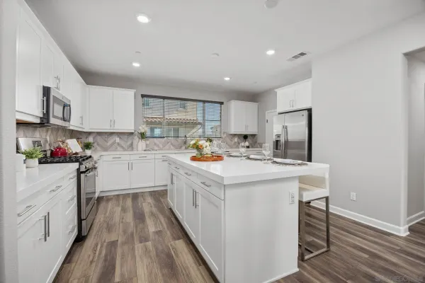a kitchen with a sink a window stainless steel appliances and cabinets
