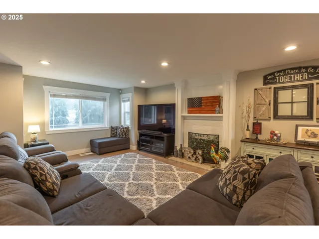 a living room with furniture a flat screen tv and a fireplace