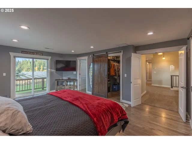 a bedroom with a bed and a large window