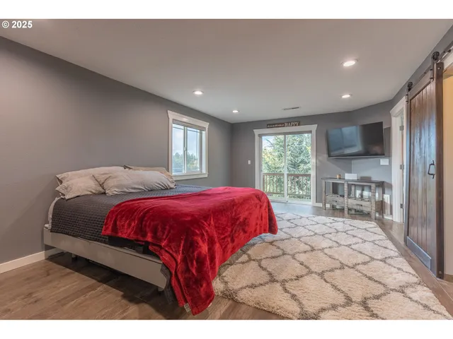 a spacious bedroom with a large bed and a large window