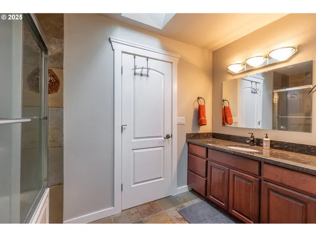 a bathroom with a double vanity sink and mirror