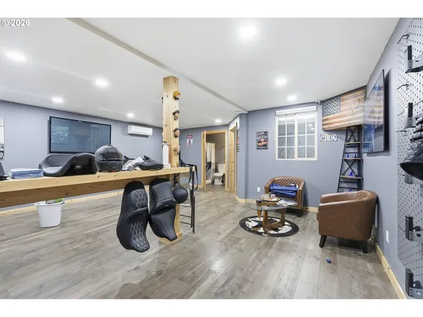 a living room with furniture a wooden floor and a sink