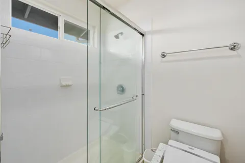 a bathroom with a shower a toilet and a sink