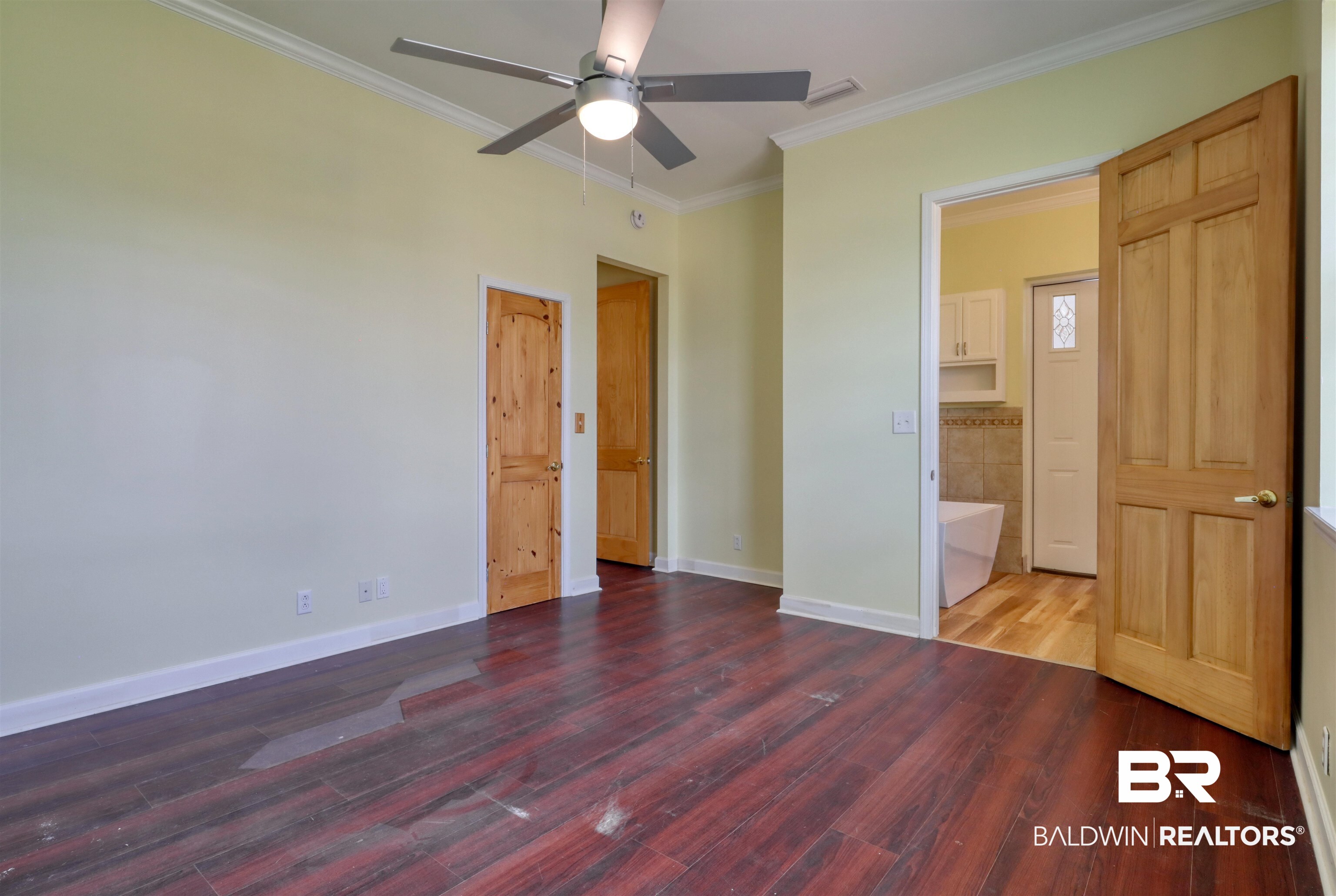 28461 Gardner Road Elberta, AL 36530 - Photo 10 of 46 Unfurnished bedroom with ornamental molding, light wood-type flooring, and a ceiling fan