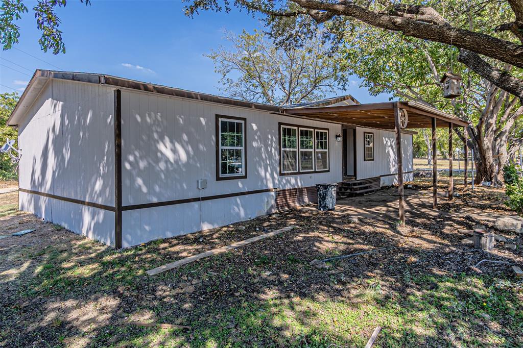 17381 Gaffield Road Justin, TX 76247 - Photo 2 of 38 a view of a house with a large tree and wooden fence