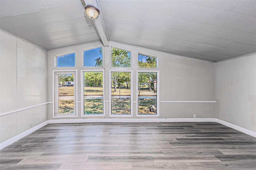 17381 Gaffield Road Justin, TX 76247 - Photo 21 of 38 a view of an empty room with window and wooden floor