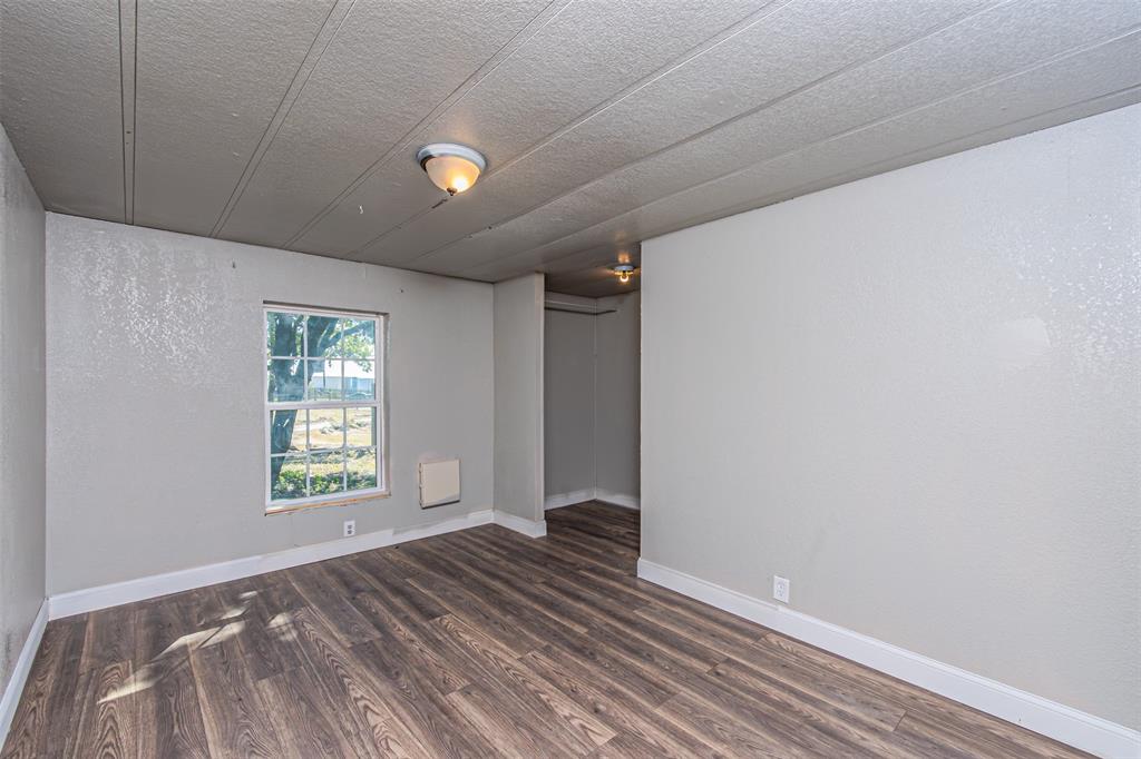 17381 Gaffield Road Justin, TX 76247 - Photo 26 of 38 a view of an empty room with wooden floor and a window