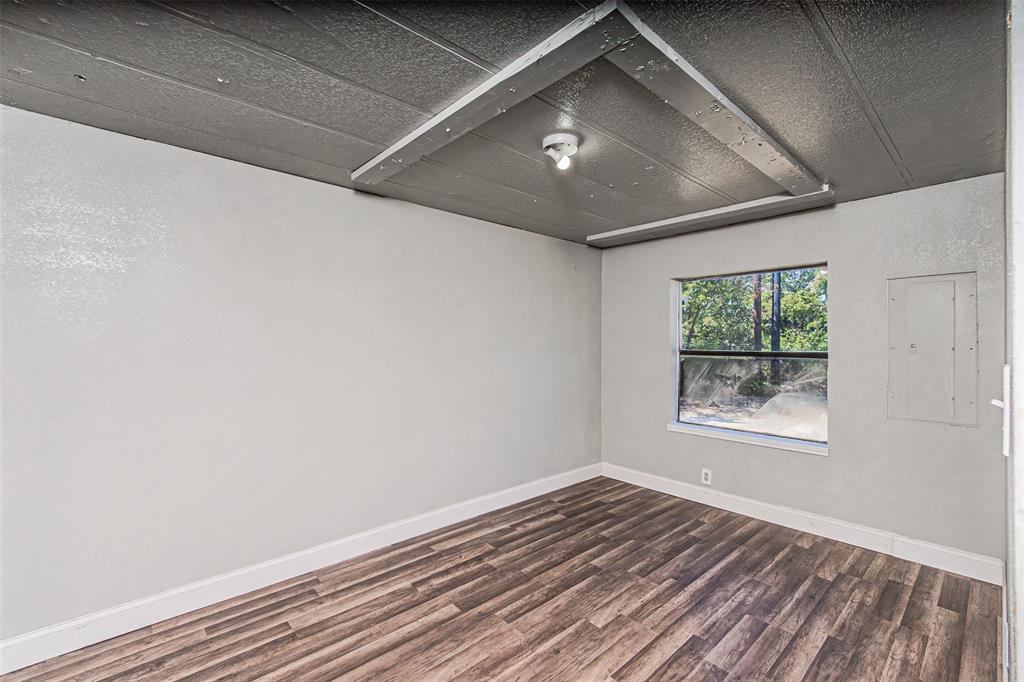 17381 Gaffield Road Justin, TX 76247 - Photo 29 of 38 a view of an empty room with wooden floor and a window