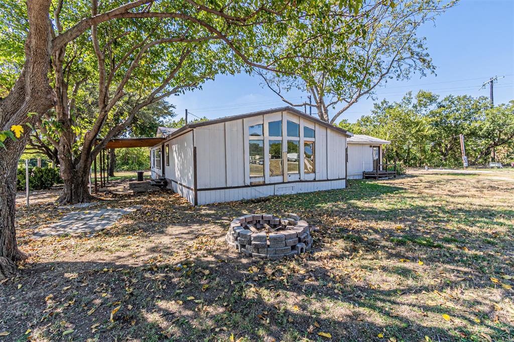 17381 Gaffield Road Justin, TX 76247 - Photo 31 of 38 a backyard of a house with wooden fence and large tree