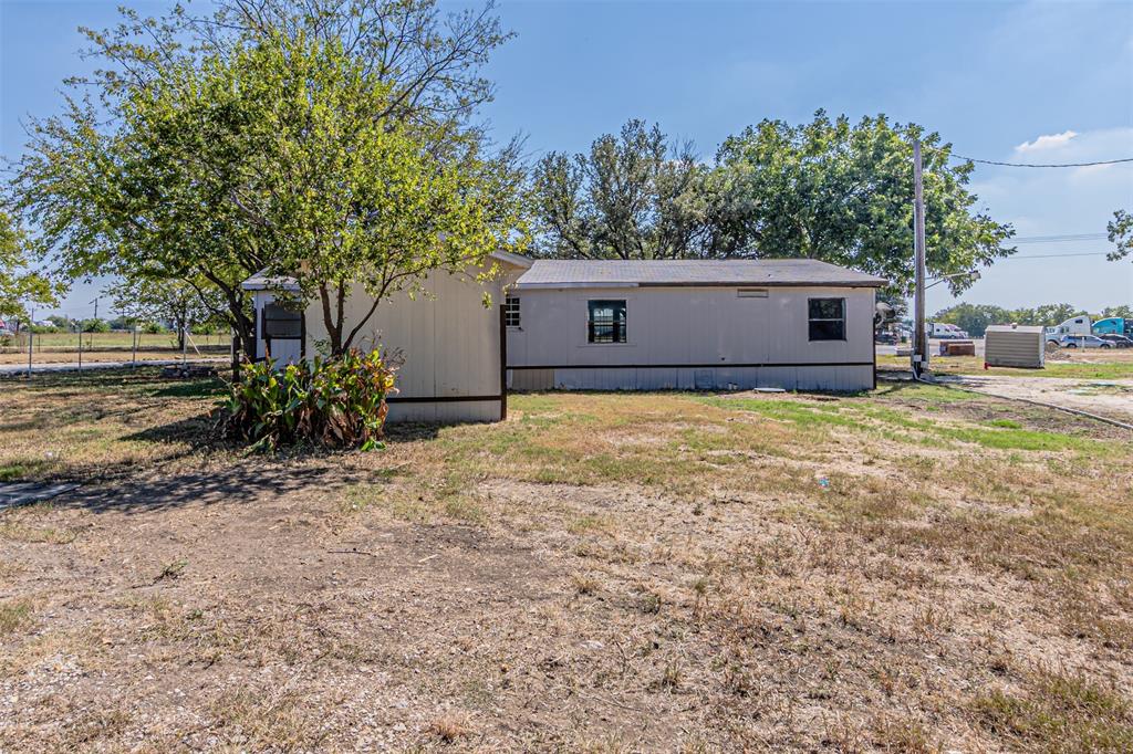 17381 Gaffield Road Justin, TX 76247 - Photo 35 of 38 a view of a house with a yard and potted plants