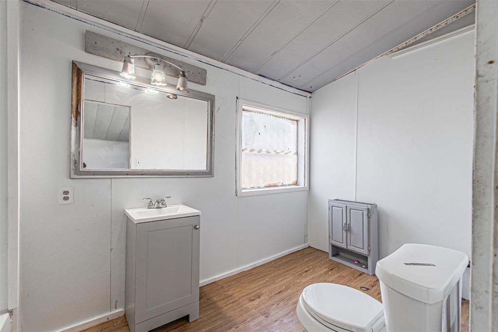 17381 Gaffield Road Justin, TX 76247 - Photo 8 of 38 a bathroom with a toilet a sink and mirror