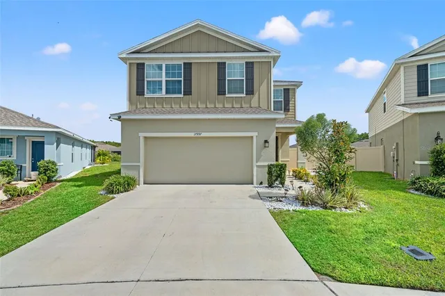 a front view of a house with a yard and garage