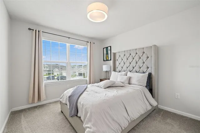 a bedroom with a large bed and a large window