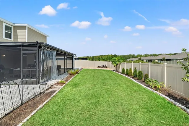a view of a house with backyard and a lake view