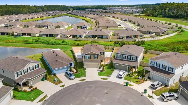 an aerial view of a house with outdoor space pool patio and outdoor seating