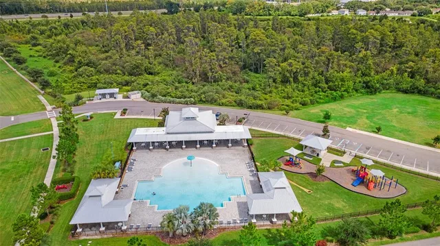 an aerial view of a house with a yard basket ball court and outdoor seating