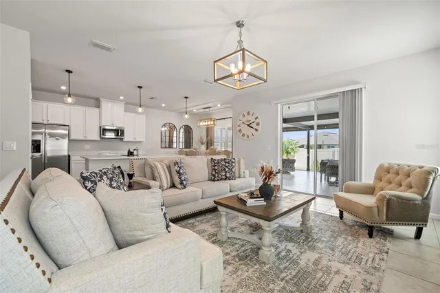 a living room with furniture wooden floor and a large window