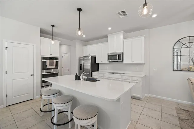 a kitchen with a sink appliances and cabinets