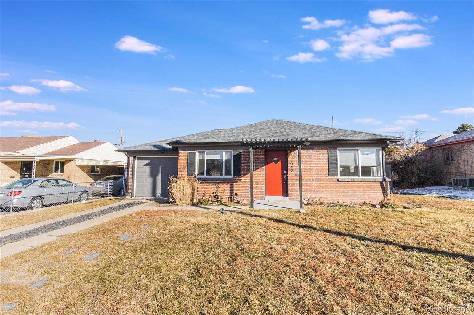 3040 Cook Street Denver, CO 80205 - Photo 1 of 19 a front view of a house with a yard