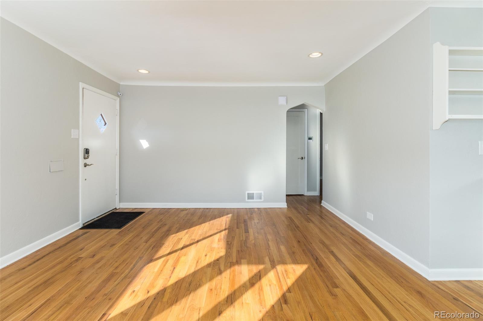 3040 Cook Street Denver, CO 80205 - Photo 11 of 19 a view of empty room with wooden floor