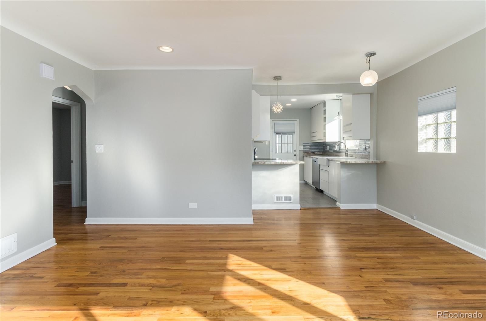 3040 Cook Street Denver, CO 80205 - Photo 12 of 19 a view of a kitchen with wooden floor and a window