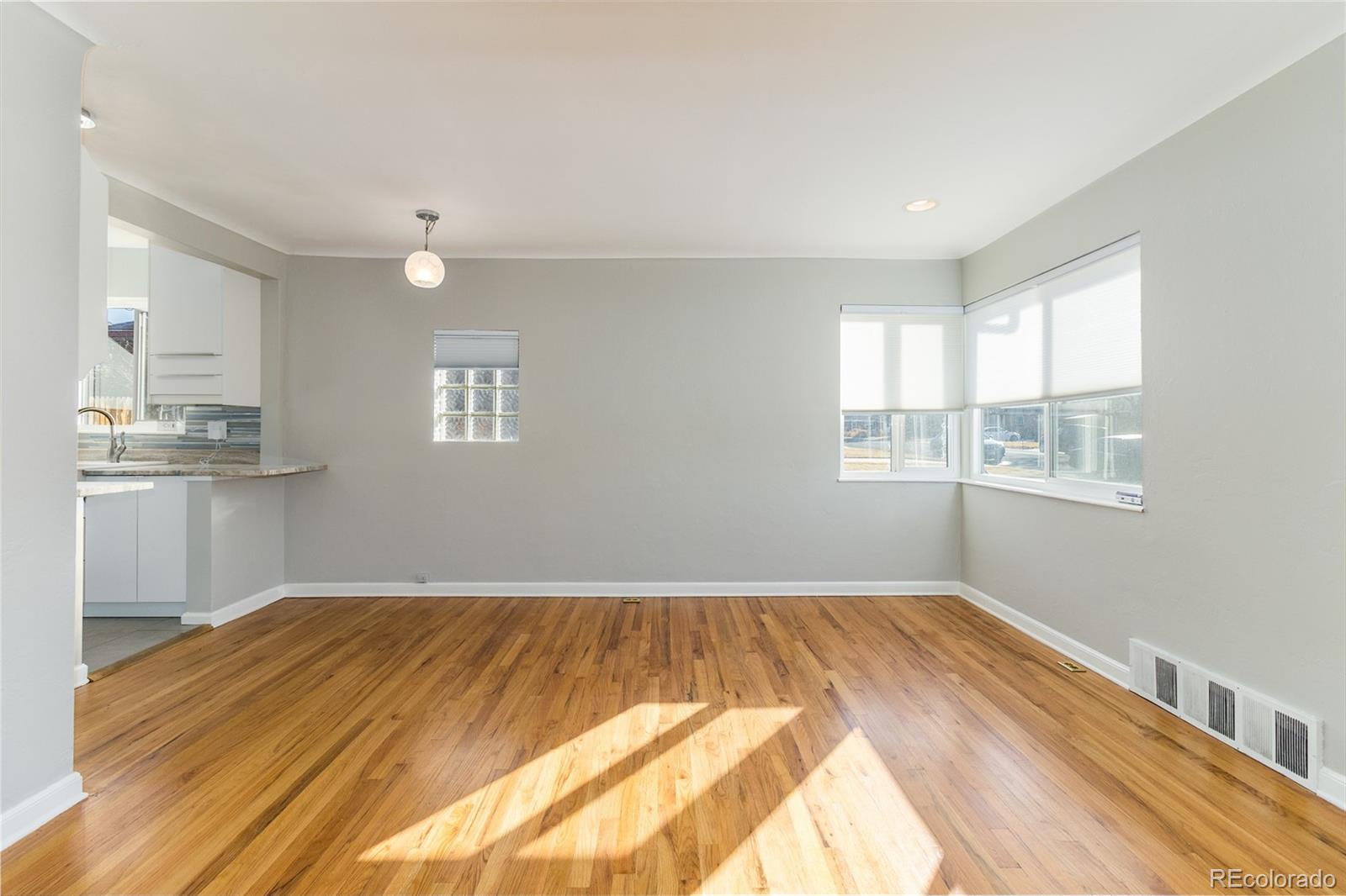 3040 Cook Street Denver, CO 80205 - Photo 13 of 19 a view of a kitchen with wooden floor and a window
