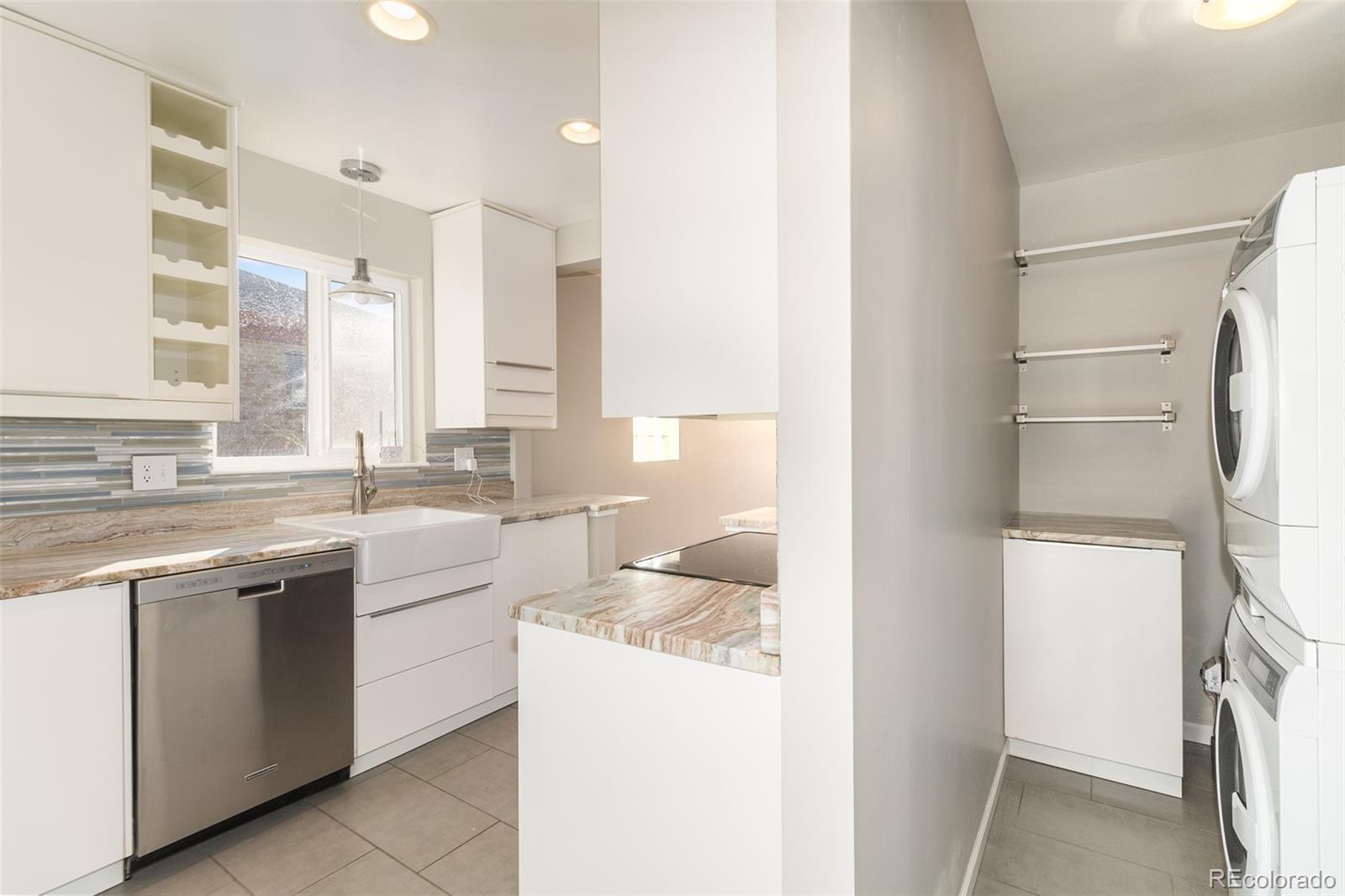 3040 Cook Street Denver, CO 80205 - Photo 14 of 19 a kitchen with a sink stove and refrigerator