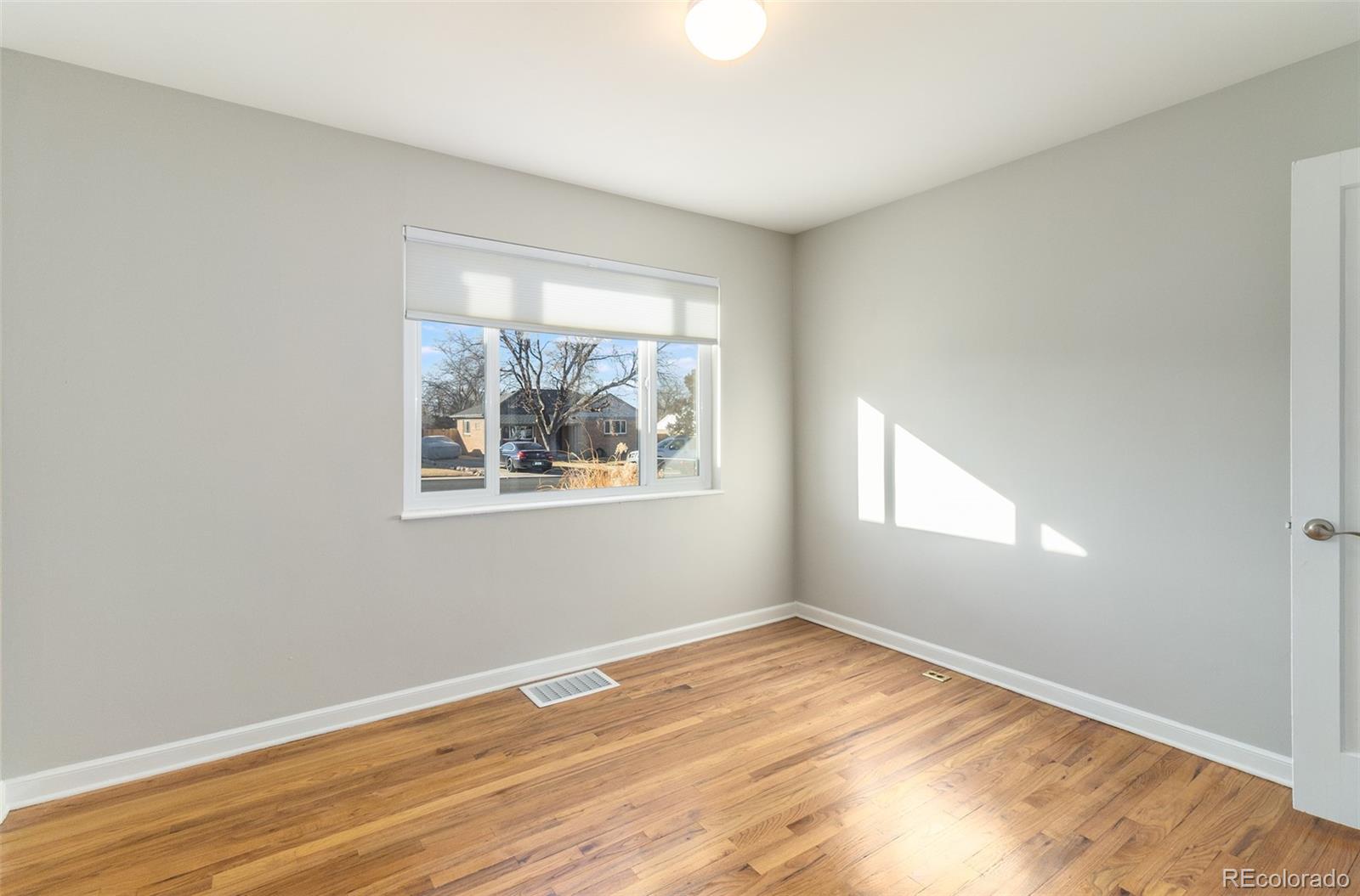 3040 Cook Street Denver, CO 80205 - Photo 16 of 19 a view of empty room with wooden floor and fan