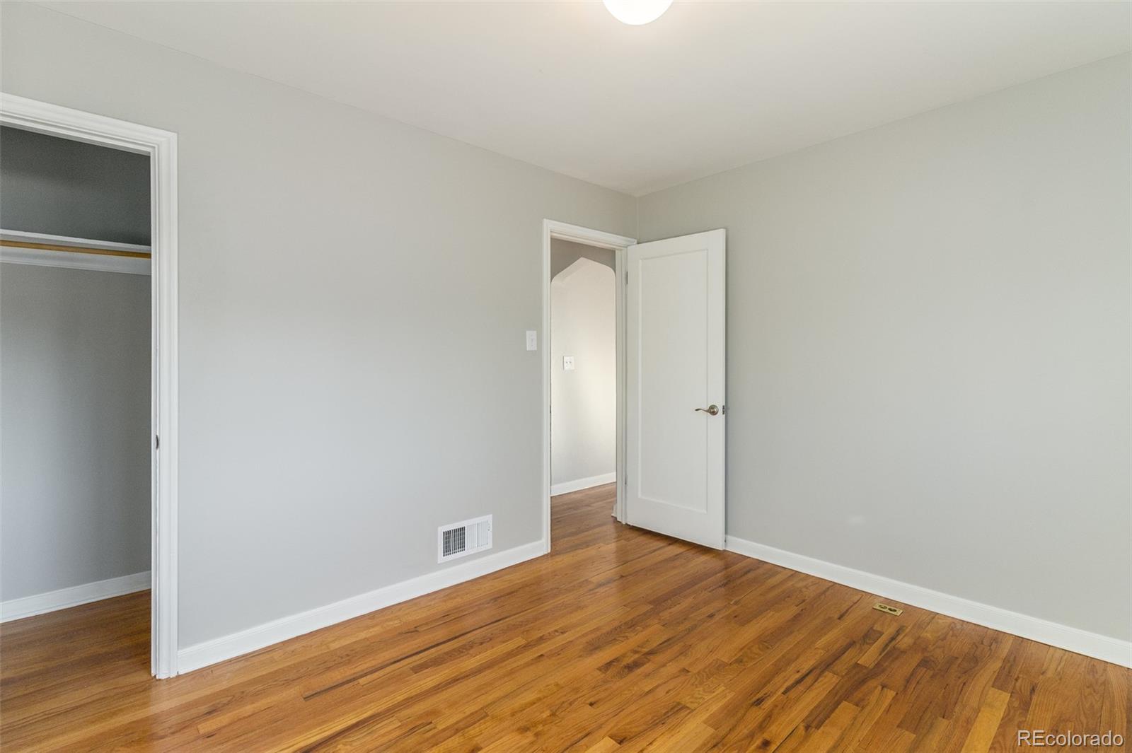 3040 Cook Street Denver, CO 80205 - Photo 17 of 19 a view of an empty room with wooden floor