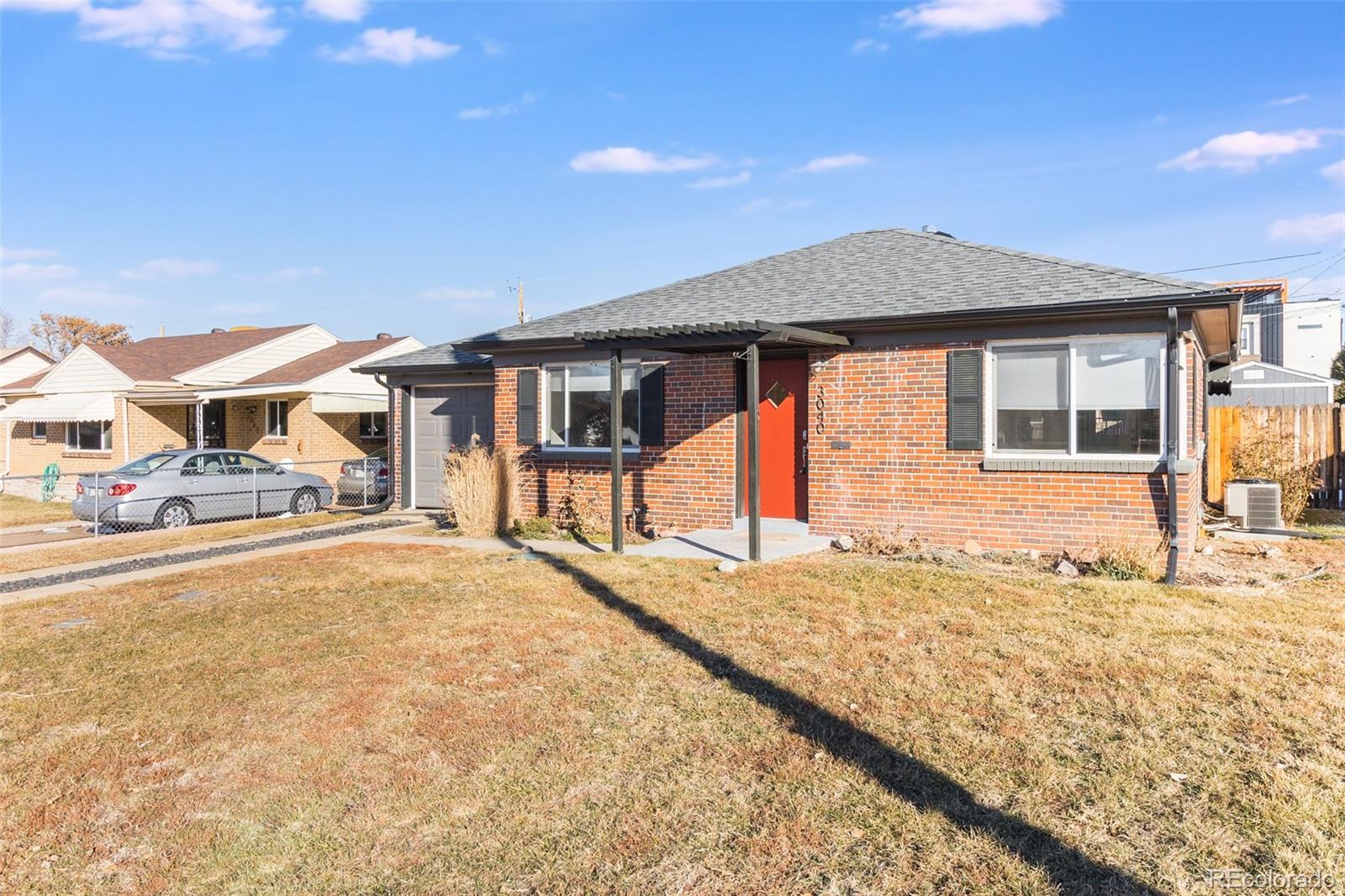 3040 Cook Street Denver, CO 80205 - Photo 19 of 19 a front view of a house with a yard