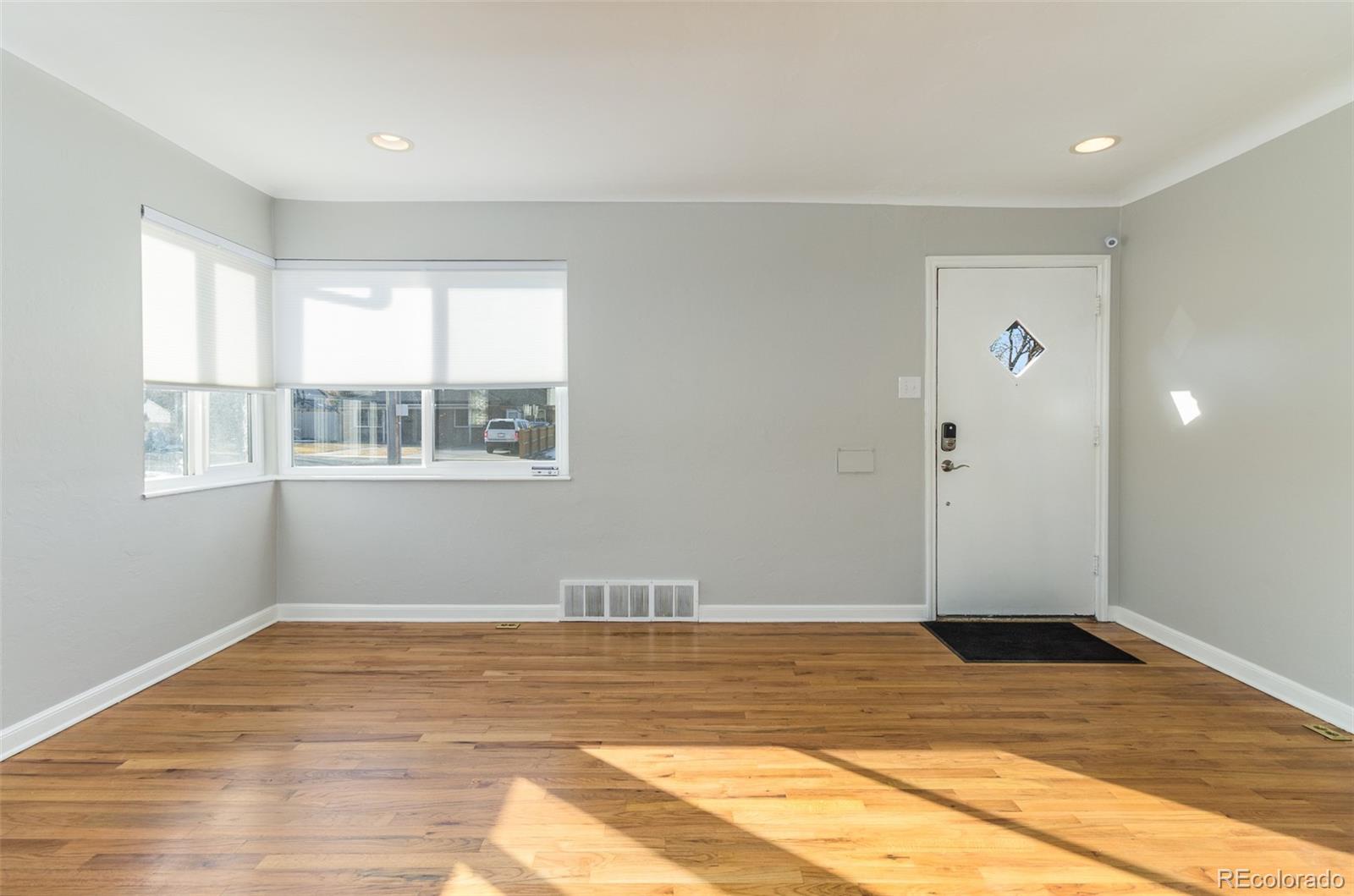 3040 Cook Street Denver, CO 80205 - Photo 5 of 19 a view of a room with wooden floor and cabinet