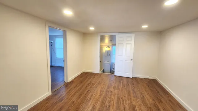 a view of empty room with wooden floor