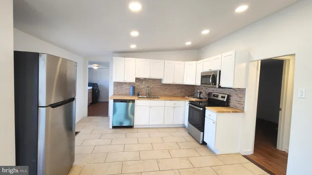 a kitchen with a refrigerator a sink and dishwasher