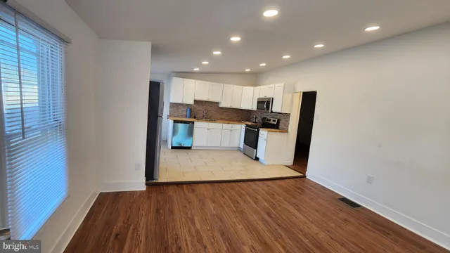 a view of kitchen with cabinets and wooden floor
