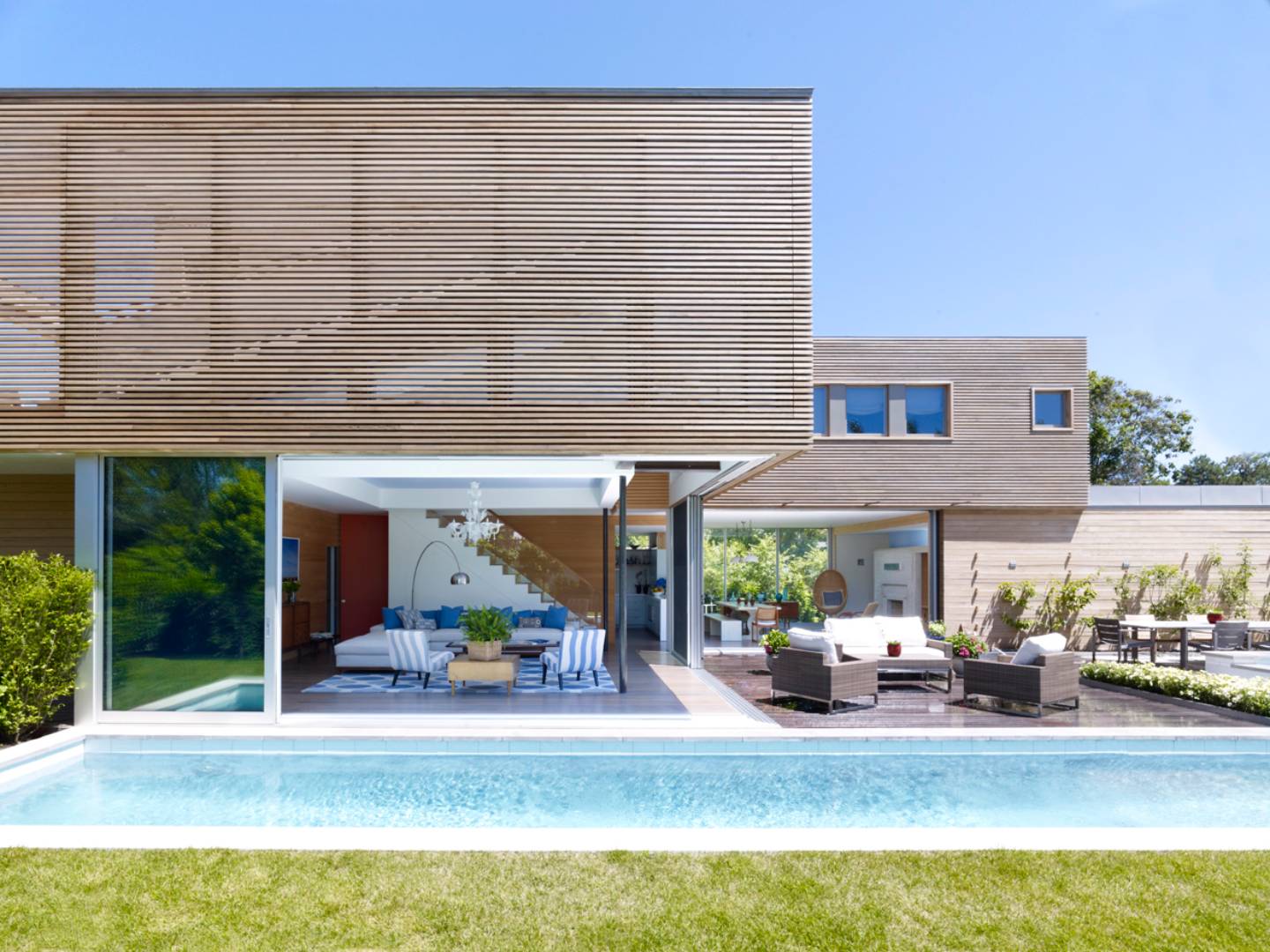 a view of a patio with table and chairs potted plants and a large tree