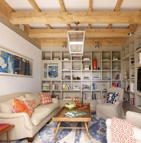 a living room with furniture and a floor to ceiling window