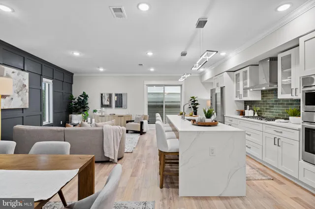 a large white kitchen with a large window