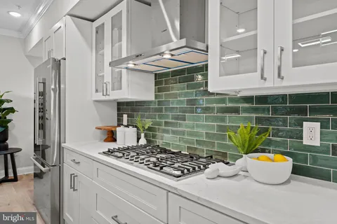 a kitchen with a sink stove and cabinets