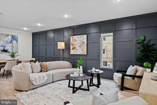 a living room with furniture a toilet and a sink