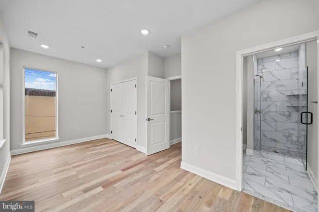 a view of empty room with wooden floor