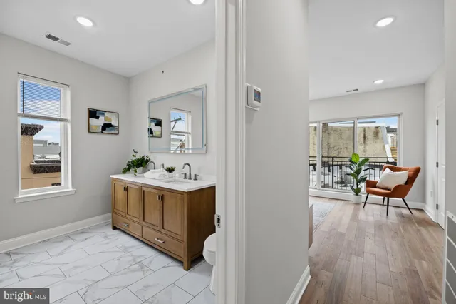 a bathroom with a sink a mirror and vanity