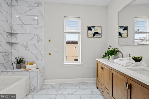 a bedroom with furniture and a large window